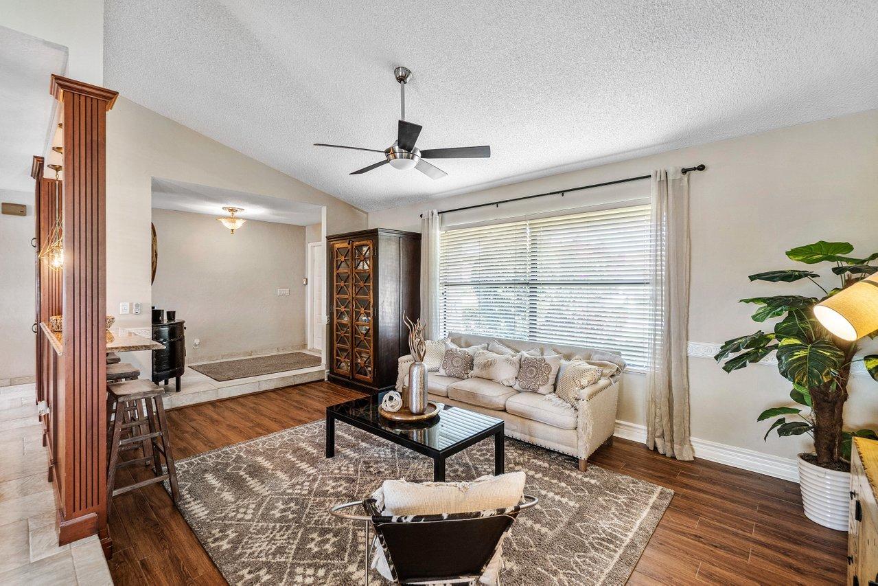 22250 Martella Avenue Boca Raton, FL 33433 - Photo 14 of 45 a living room with furniture and a potted plant