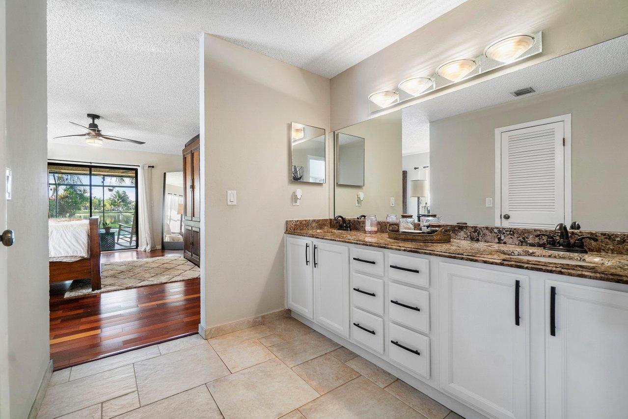 22250 Martella Avenue Boca Raton, FL 33433 - Photo 17 of 45 a bathroom with a sink and a mirror