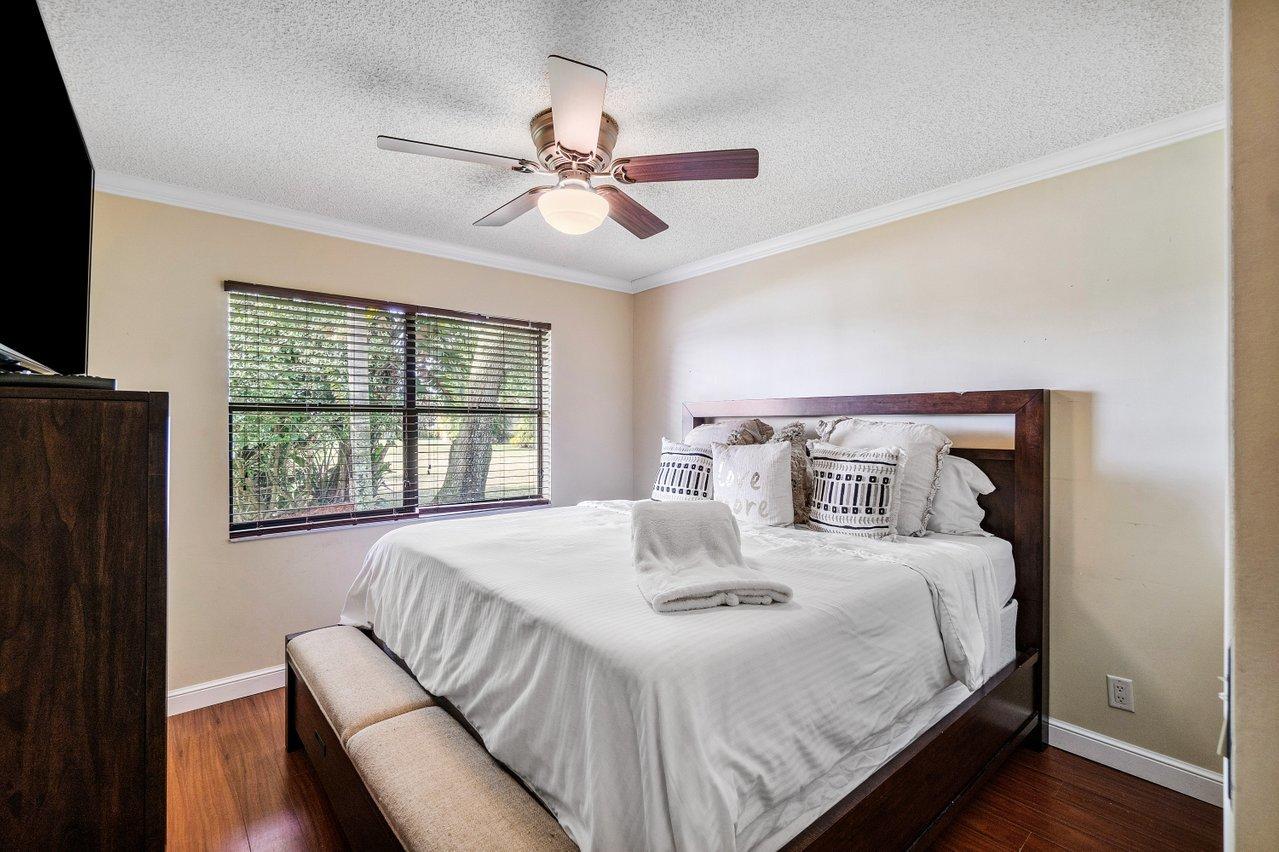 22250 Martella Avenue Boca Raton, FL 33433 - Photo 20 of 45 a bedroom with a bed and a flat screen tv
