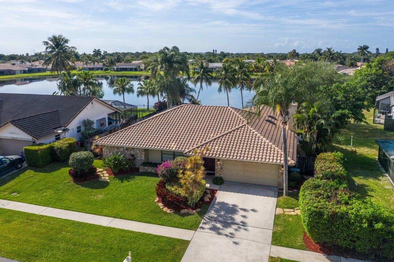 22250 Martella Avenue Boca Raton, FL 33433 - Photo 2 of 45 a view of a back yard of the house and green space