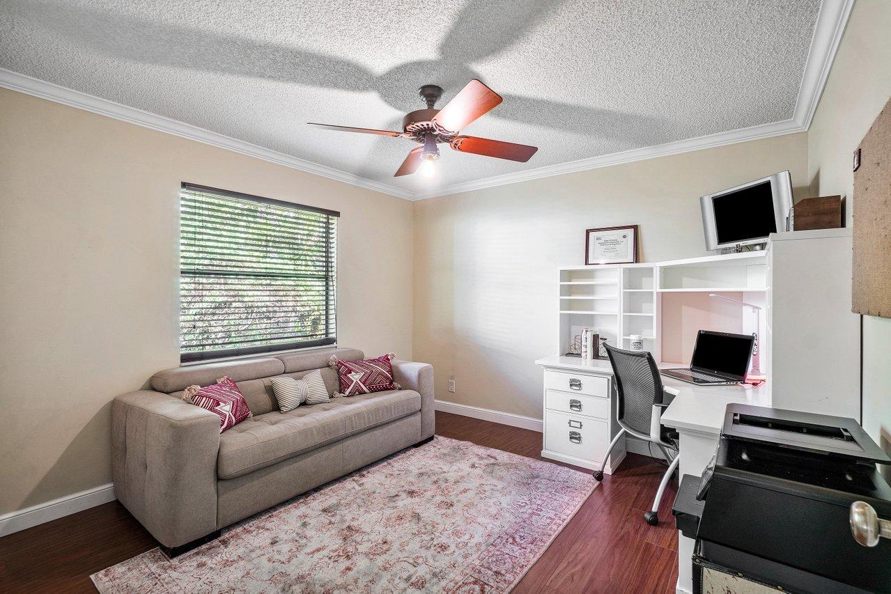 22250 Martella Avenue Boca Raton, FL 33433 - Photo 21 of 45 a living room with furniture a fireplace and a flat screen tv