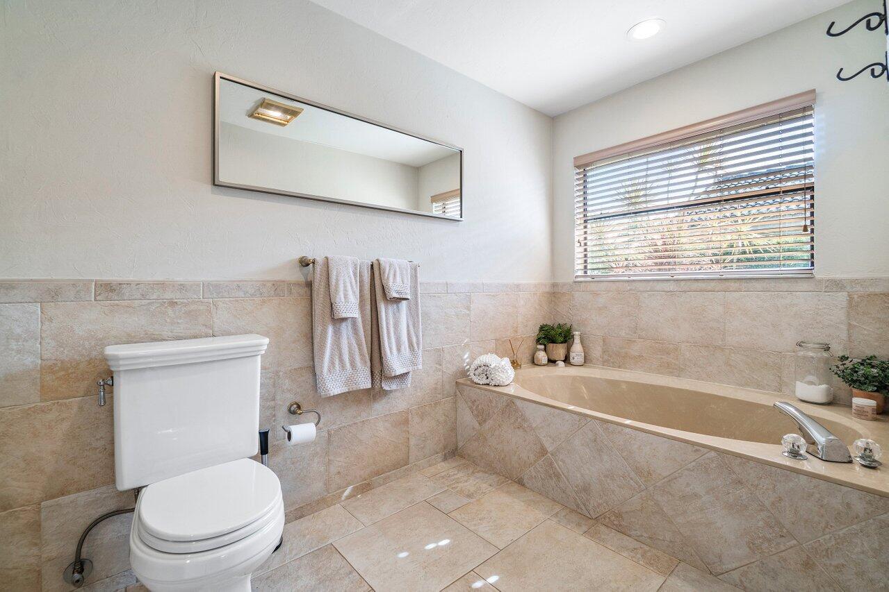 22250 Martella Avenue Boca Raton, FL 33433 - Photo 22 of 45 a bathroom with a toilet a sink and bathtub