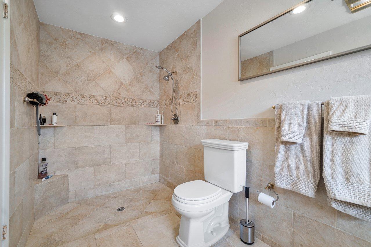 22250 Martella Avenue Boca Raton, FL 33433 - Photo 23 of 45 a bathroom with a toilet and shower