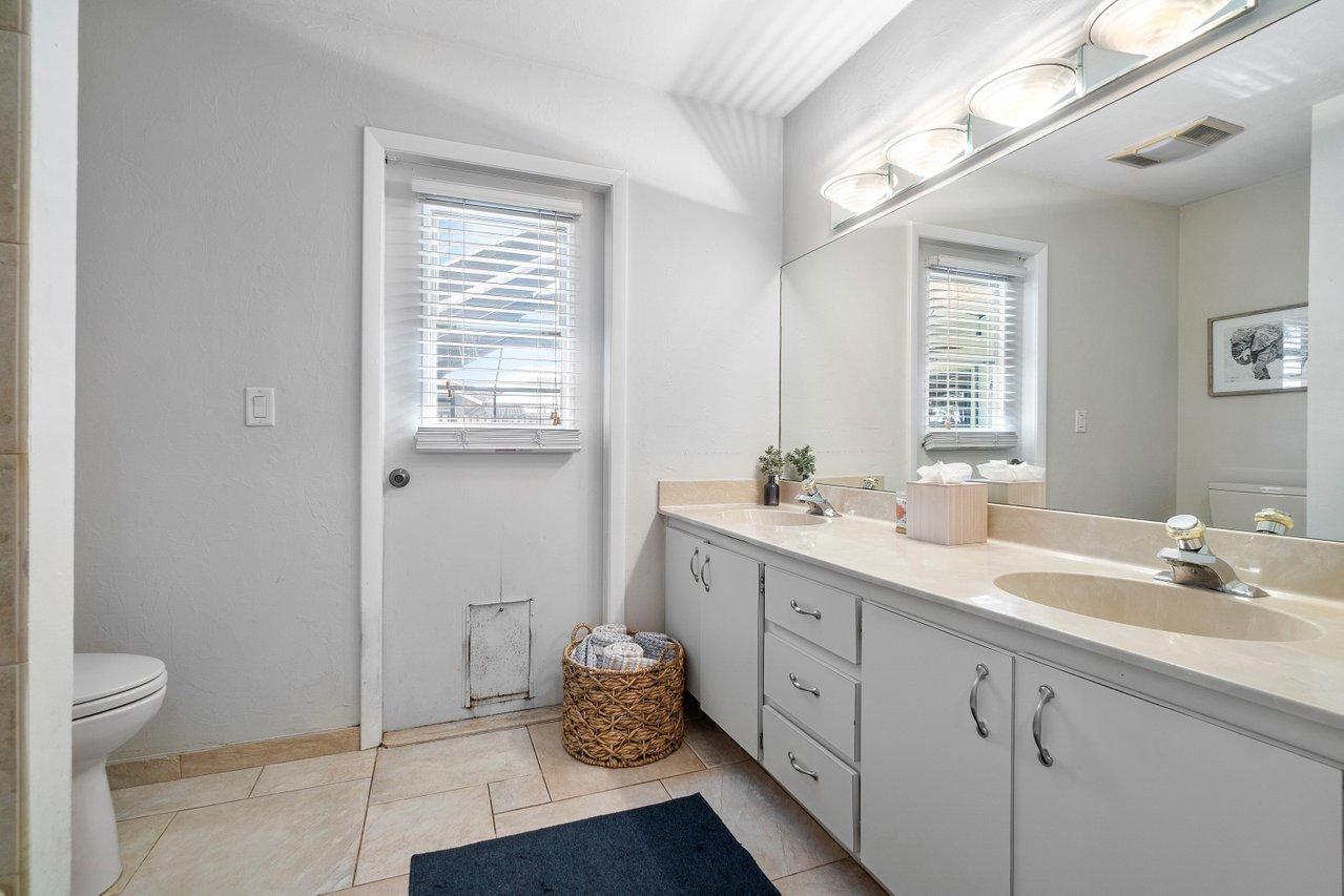 22250 Martella Avenue Boca Raton, FL 33433 - Photo 24 of 45 a spacious bathroom with a double vanity sink toilet and a mirror