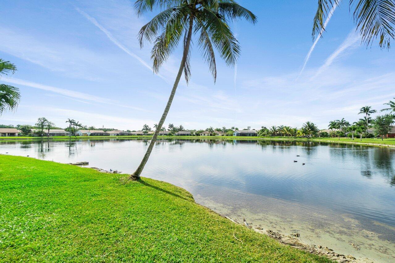 22250 Martella Avenue Boca Raton, FL 33433 - Photo 31 of 45 a lake view with a garden