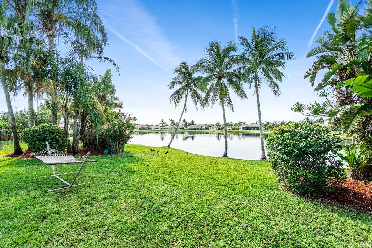 22250 Martella Avenue Boca Raton, FL 33433 - Photo 32 of 45 a view of a backyard with a garden