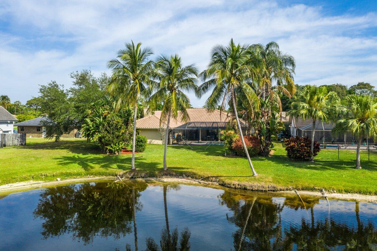 22250 Martella Avenue Boca Raton, FL 33433 - Photo 34 of 45 a view of a house with a yard and palm trees