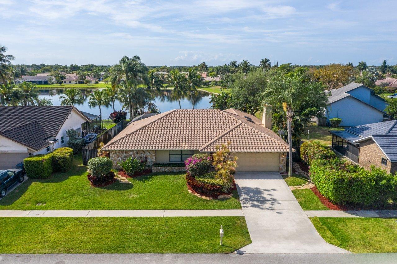 22250 Martella Avenue Boca Raton, FL 33433 - Photo 35 of 45 a front view of a house with garden