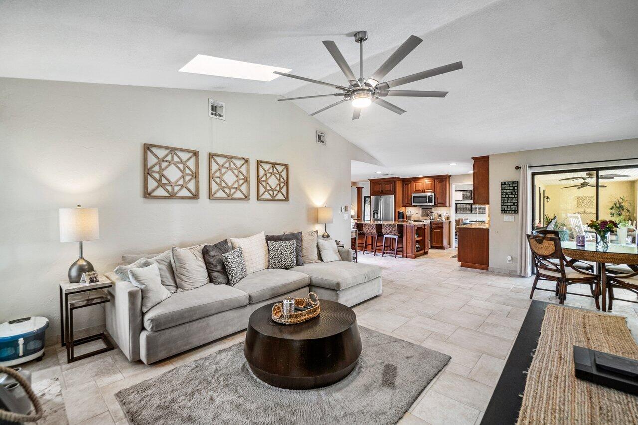 22250 Martella Avenue Boca Raton, FL 33433 - Photo 4 of 45 a living room with furniture and a chandelier