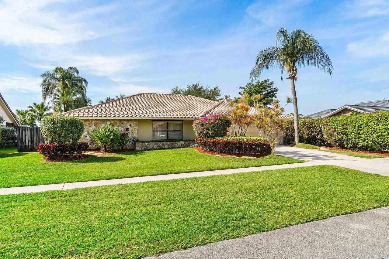 22250 Martella Avenue Boca Raton, FL 33433 - Photo 43 of 45 a view of a house with a big yard and palm trees