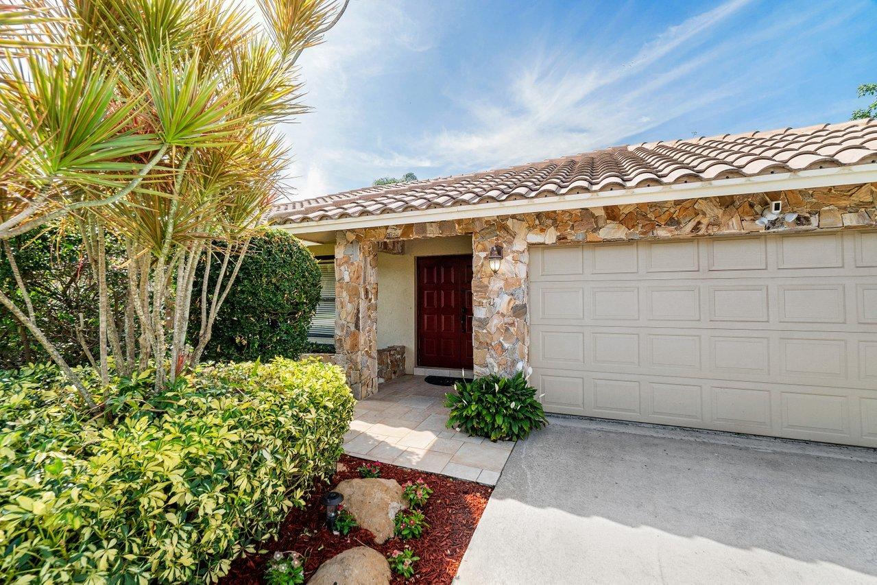 22250 Martella Avenue Boca Raton, FL 33433 - Photo 45 of 45 a view of a house with a flower garden