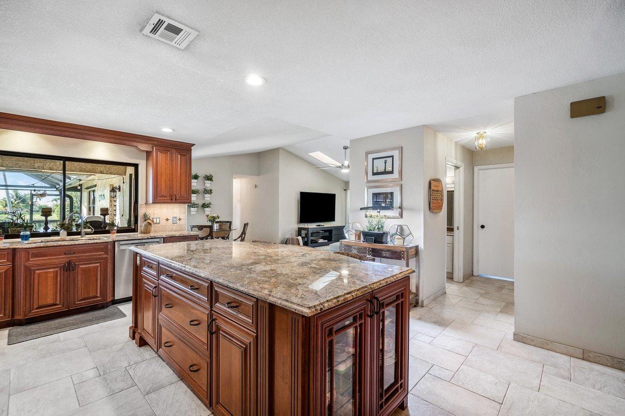22250 Martella Avenue Boca Raton, FL 33433 - Photo 8 of 45 a kitchen with a stove and a refrigerator