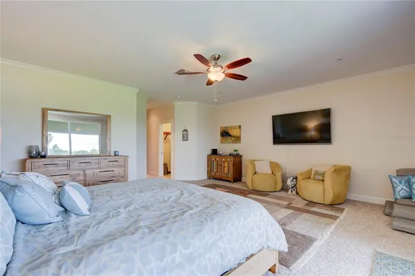 a bedroom with bed and a flat screen tv