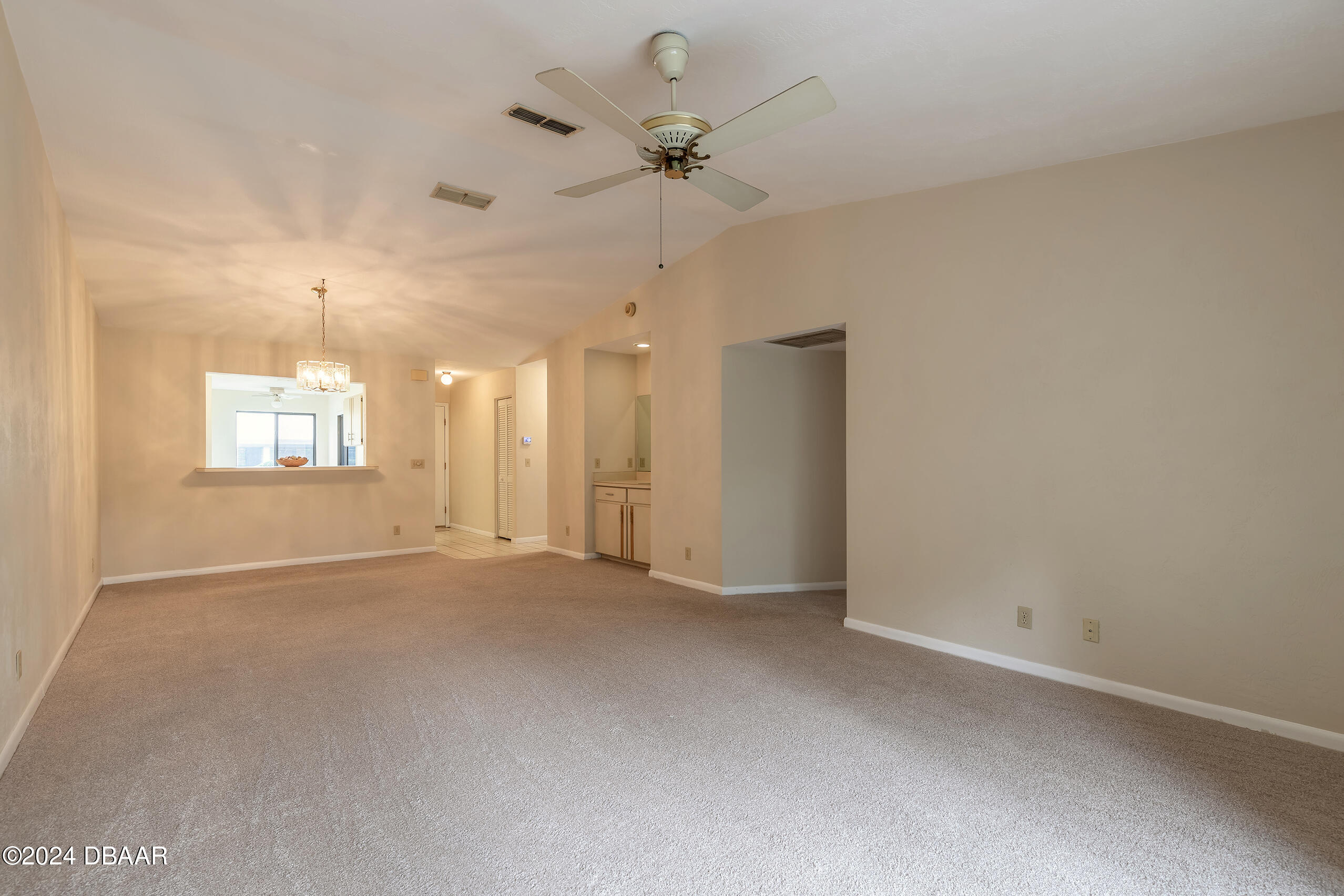 251 Orange Grove Drive, Unit 2 Ormond Beach, FL 32174 - Photo 12 of 32 an empty room with a ceiling fan and windows
