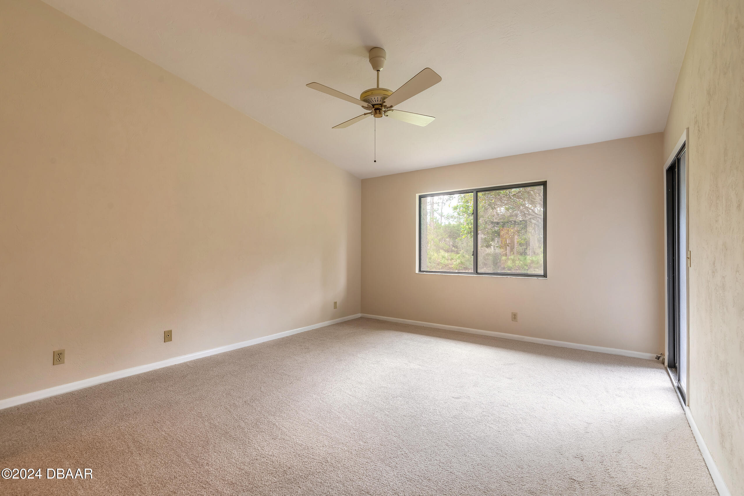 251 Orange Grove Drive, Unit 2 Ormond Beach, FL 32174 - Photo 15 of 32 an empty room with a window and a fan