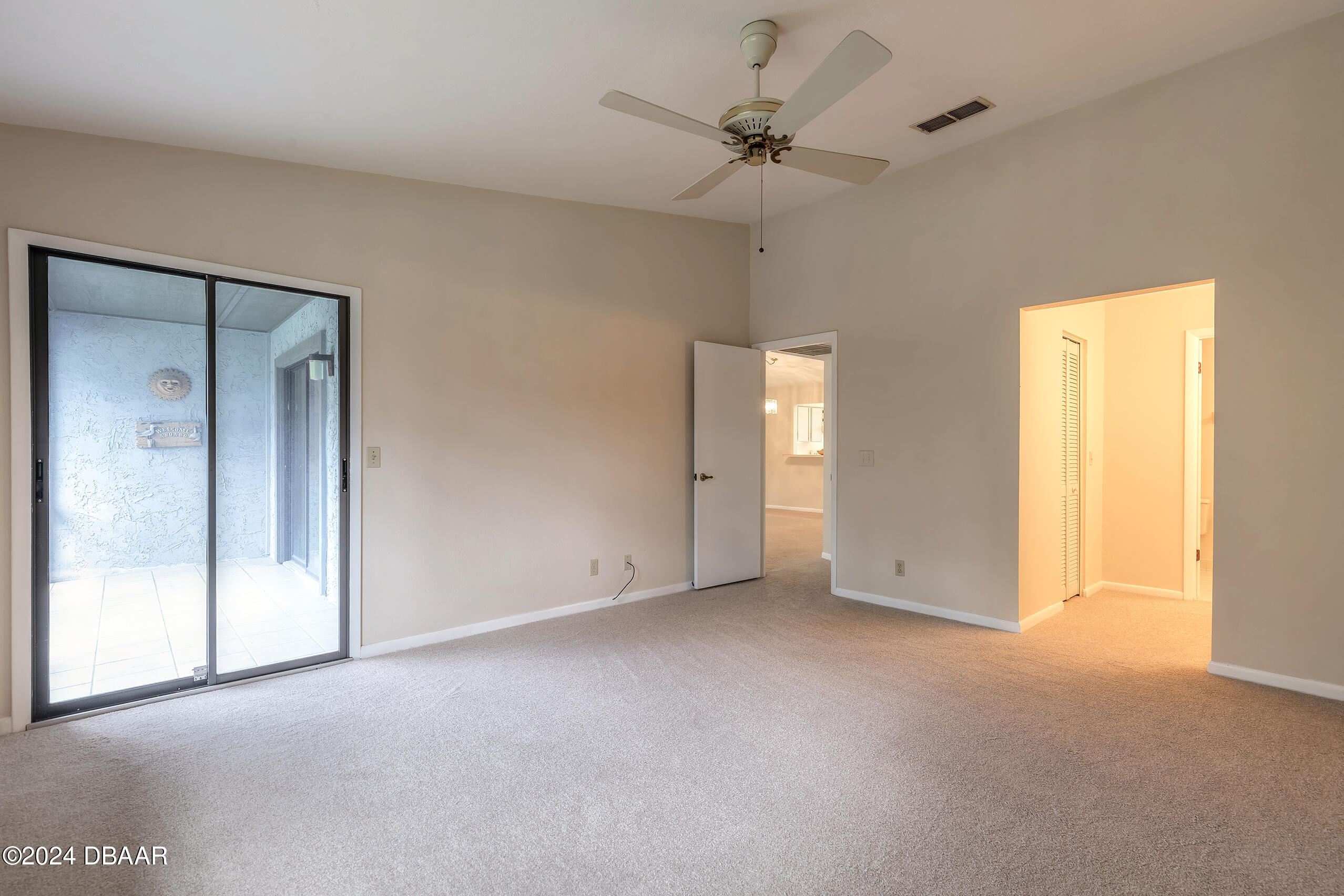 251 Orange Grove Drive, Unit 2 Ormond Beach, FL 32174 - Photo 16 of 32 a view of an empty room and a ceiling fan