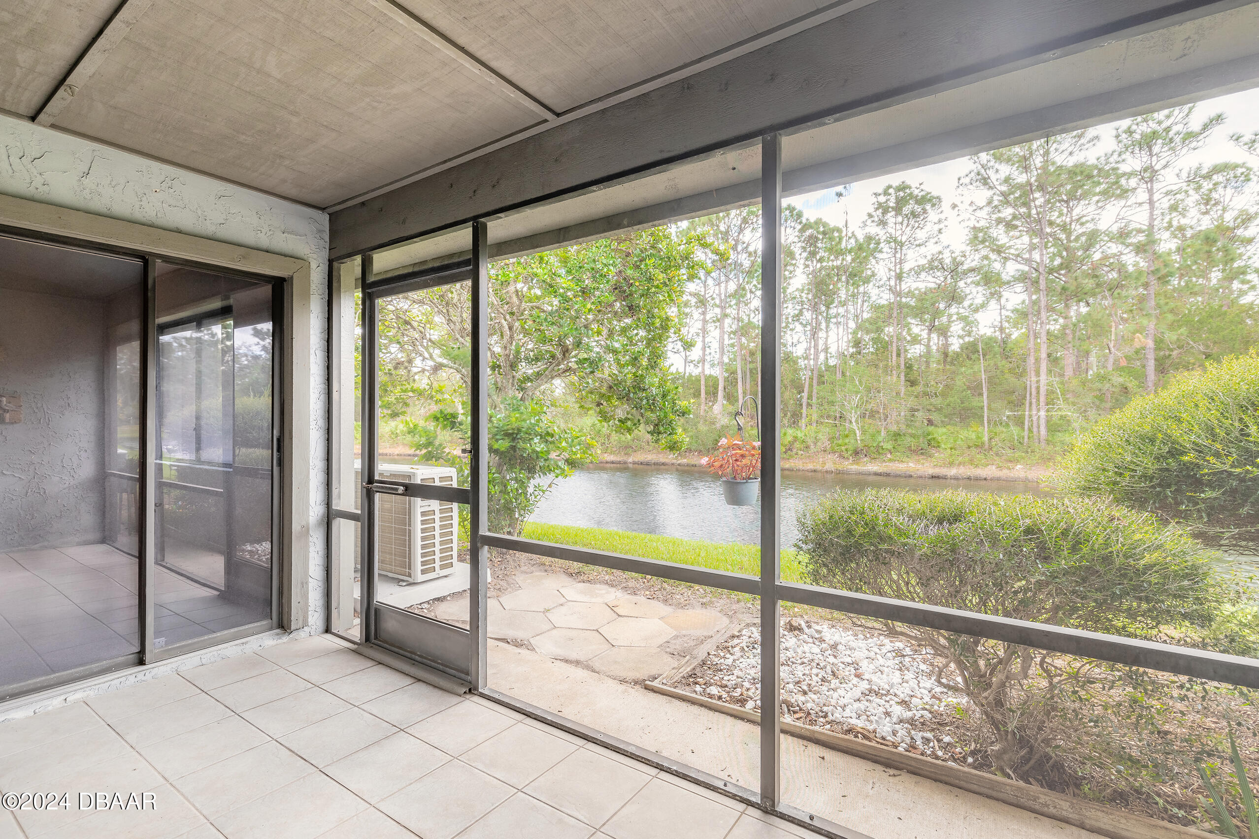 251 Orange Grove Drive, Unit 2 Ormond Beach, FL 32174 - Photo 22 of 32 a bedroom with a large window and a bed