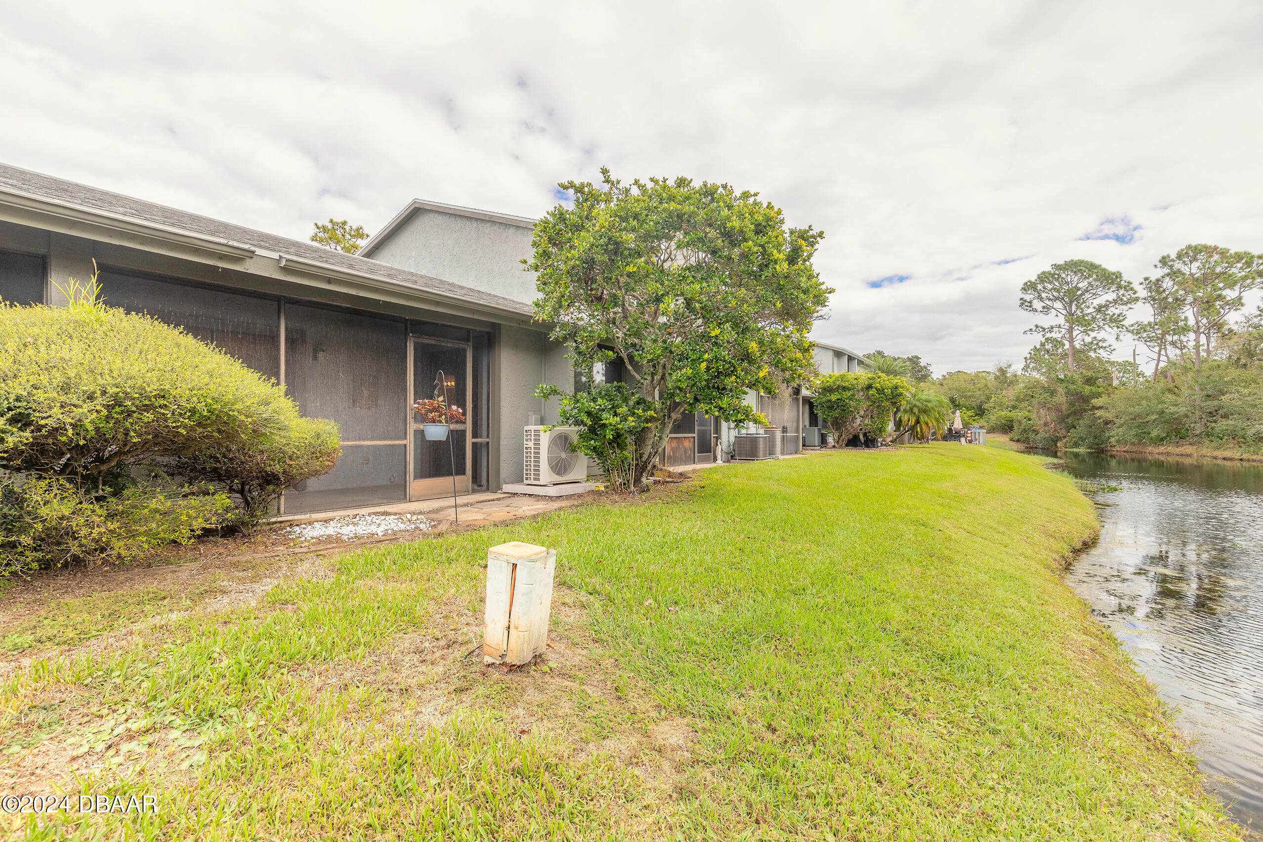 251 Orange Grove Drive, Unit 2 Ormond Beach, FL 32174 - Photo 23 of 32 a view of a house with pool and garden