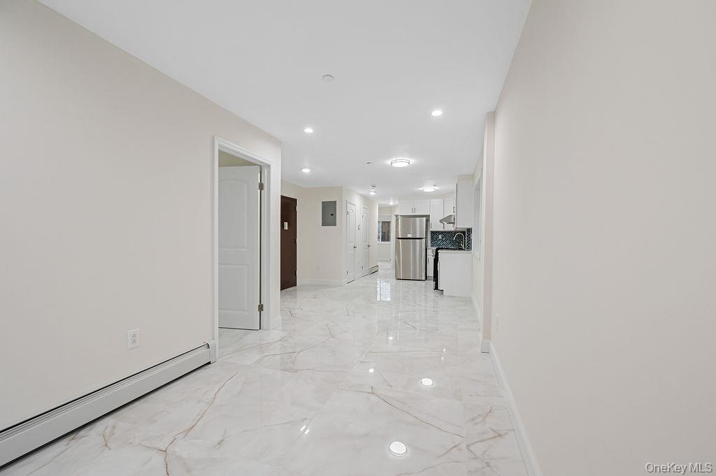 106-05 49th Avenue Queens, NY 11368 - Photo 20 of 39 a view of a kitchen with a refrigerator and a sink