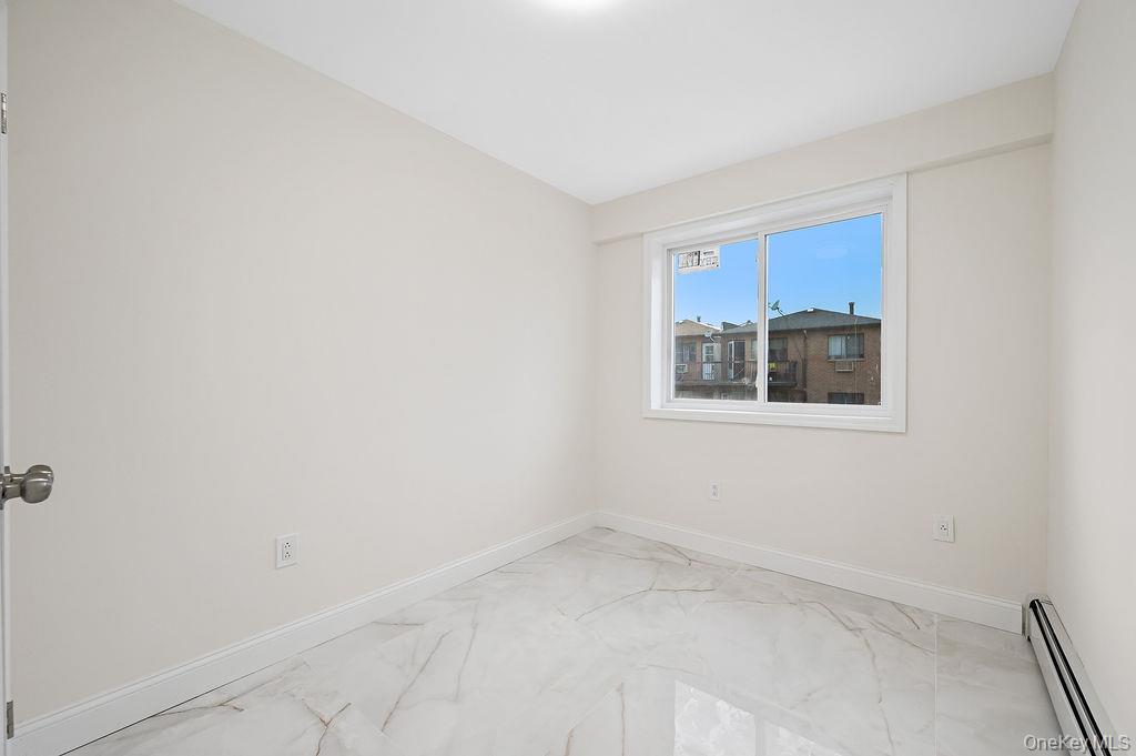 106-05 49th Avenue Queens, NY 11368 - Photo 23 of 39 a view of a room with a white wall and a window