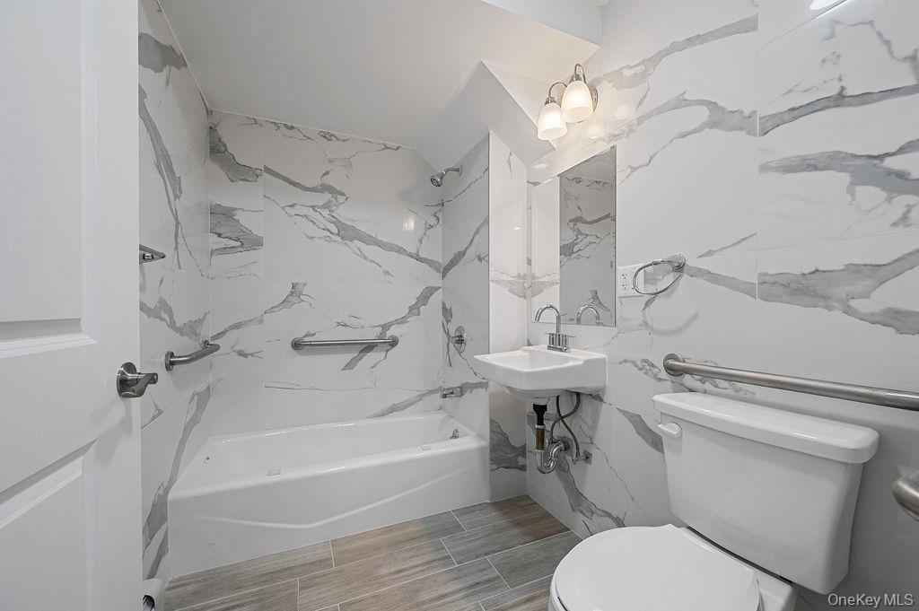 106-05 49th Avenue Queens, NY 11368 - Photo 29 of 39 a bathroom with a sink a toilet and a bathtub