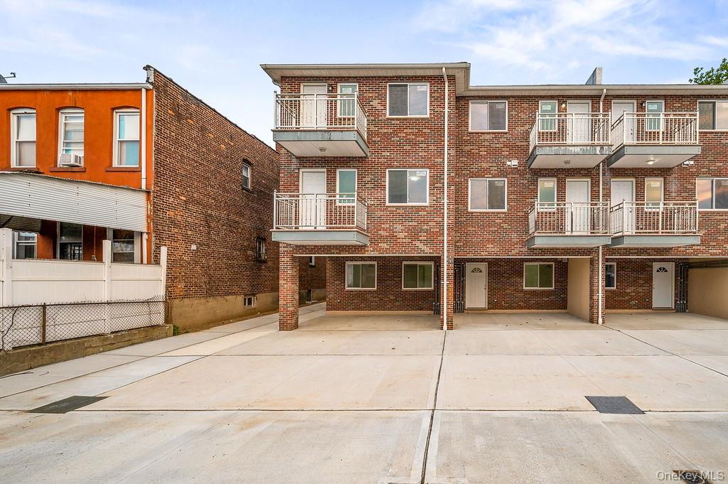 106-05 49th Avenue Queens, NY 11368 - Photo 3 of 39 a front view of a building with glass windows