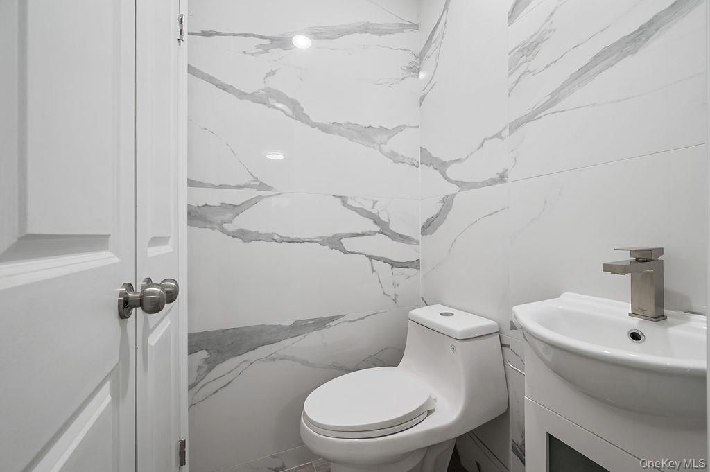 106-05 49th Avenue Queens, NY 11368 - Photo 8 of 39 a white toilet sitting next to a bathroom sink