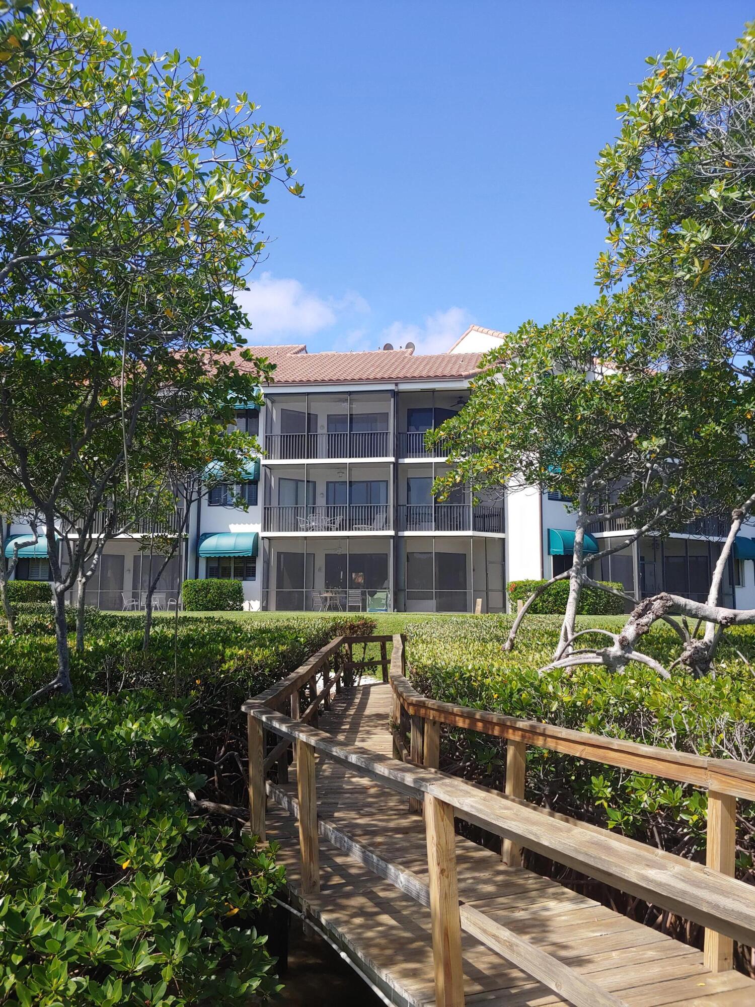 200 Waterway Road, Unit 307 Tequesta, FL 33469 - Photo 4 of 8 a house view with a garden space