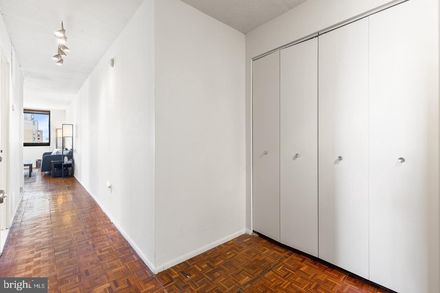1420 Locust Street, Unit 29J Philadelphia, PA 19102 - Photo 17 of 30 a view of a hallway with wooden floor and a bathroom