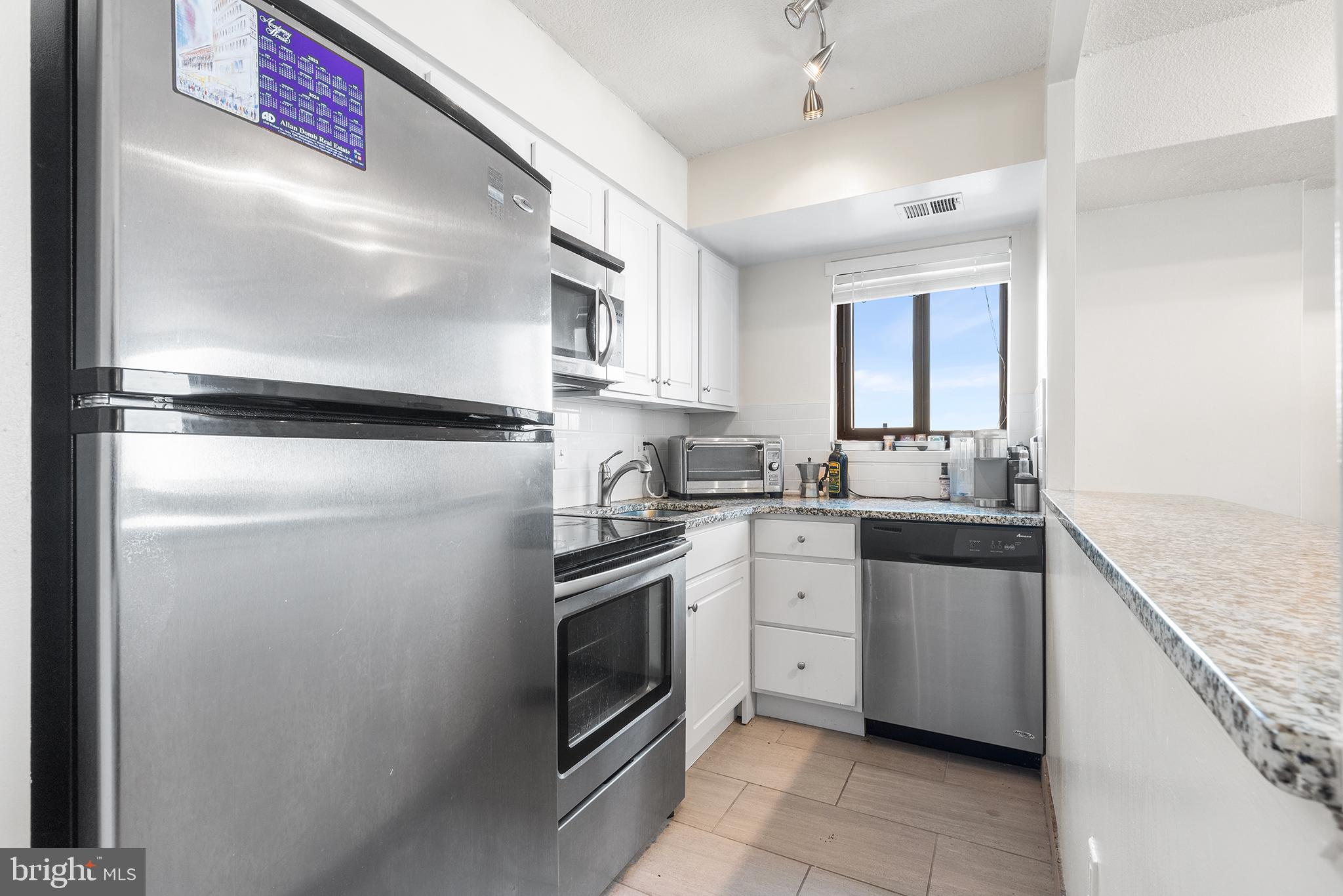 1420 Locust Street, Unit 29J Philadelphia, PA 19102 - Photo 24 of 30 a kitchen with cabinets stainless steel appliances and sink