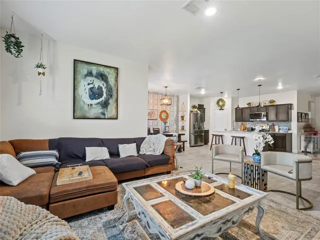 a living room with furniture and kitchen view