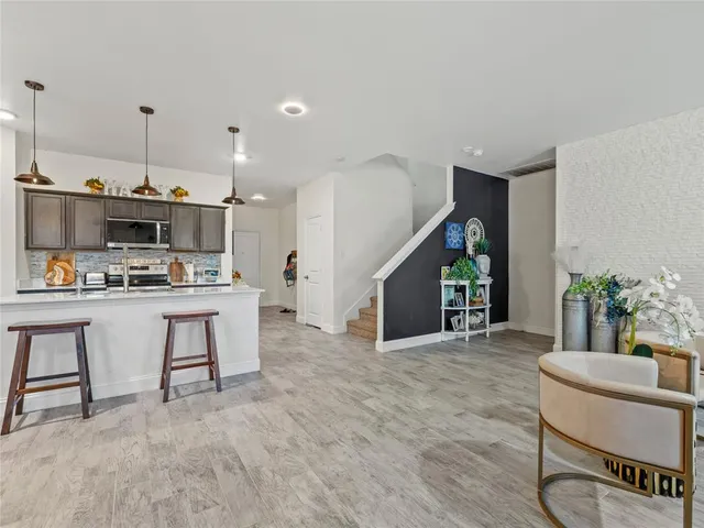 a view of kitchen with furniture and refrigerator