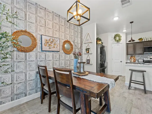 a view of a dining area with furniture and chandelier