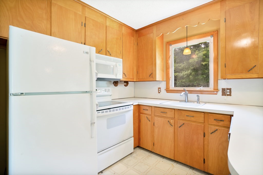 316 Burlingame Road Palmer, MA 01069 - Photo 18 of 31 a kitchen with a sink a refrigerator and window