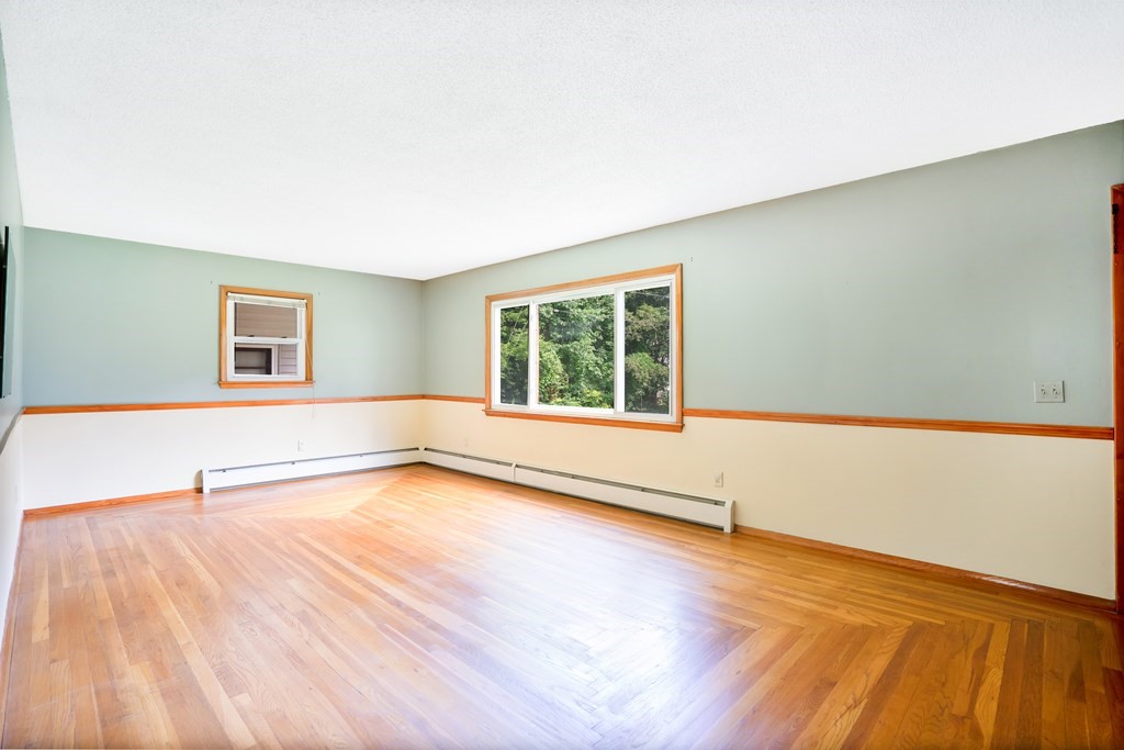 316 Burlingame Road Palmer, MA 01069 - Photo 19 of 31 a view of an empty room with wooden floor and a window