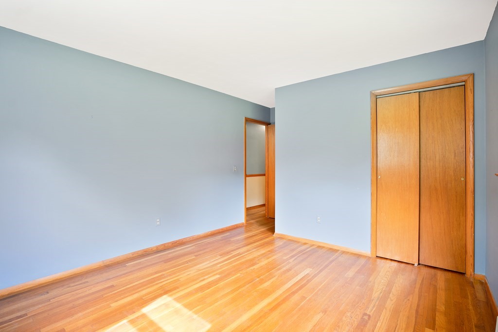 316 Burlingame Road Palmer, MA 01069 - Photo 27 of 31 an empty room with wooden floor and sliding door