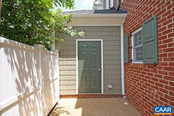 a front view of a house with yard and green space