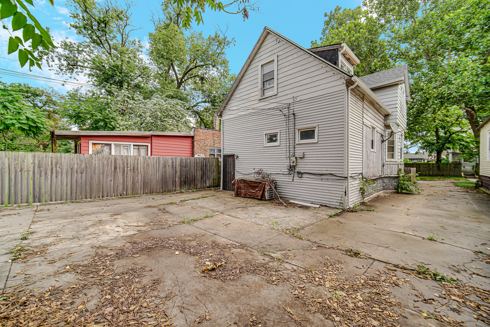 12220 South Normal Avenue Chicago, IL 60628 - Photo 20 of 22 a view of backyard with wooden fence and a large tree