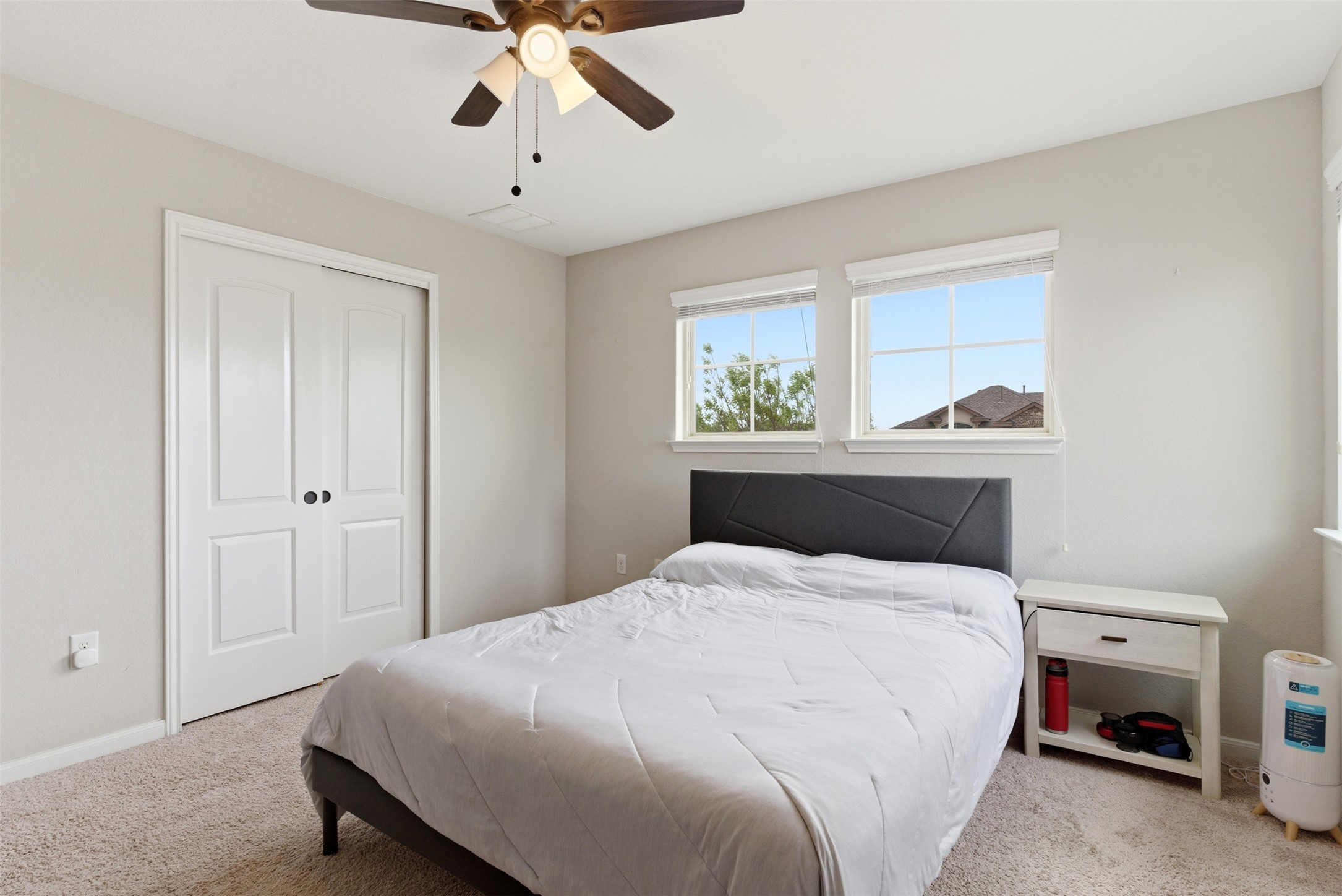 2409 Muzzie Lane Leander, TX 78641 - Photo 17 of 33 a bedroom with a bed and a chandelier