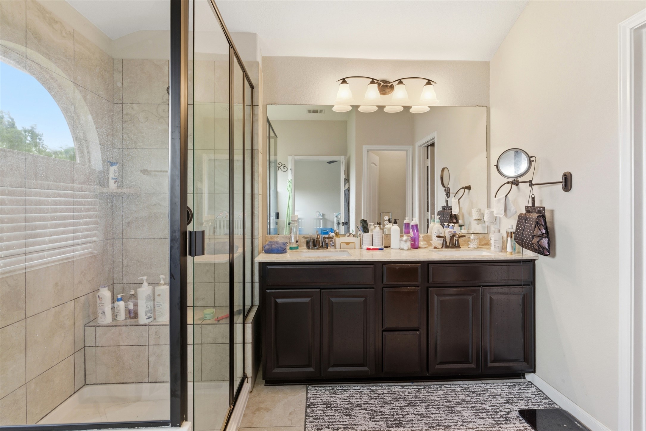 2409 Muzzie Lane Leander, TX 78641 - Photo 23 of 33 a bathroom with a sink and a mirror with shower