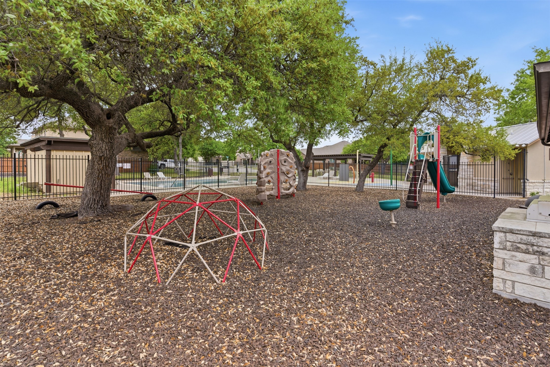 2409 Muzzie Lane Leander, TX 78641 - Photo 33 of 33 a backyard of a house with trampoline fire pit tables and chairs