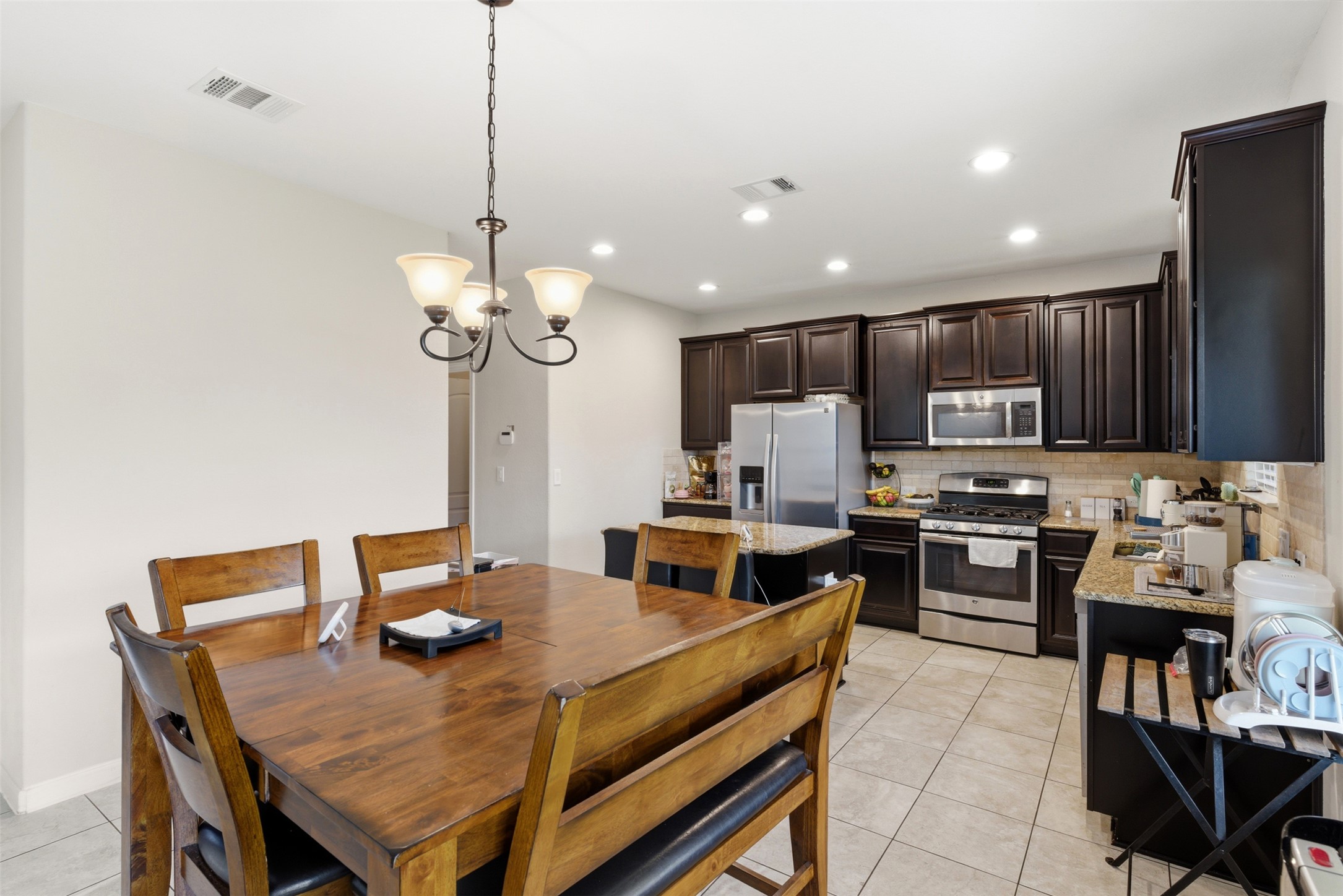 2409 Muzzie Lane Leander, TX 78641 - Photo 10 of 33 a view of a dining room and kitchen with a table chairs