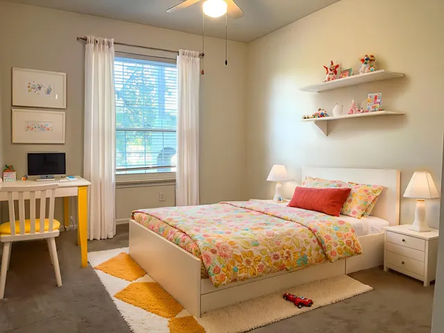 a bedroom with a bed and a window