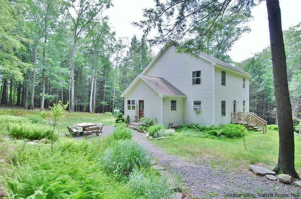 a view of backyard of house with green space