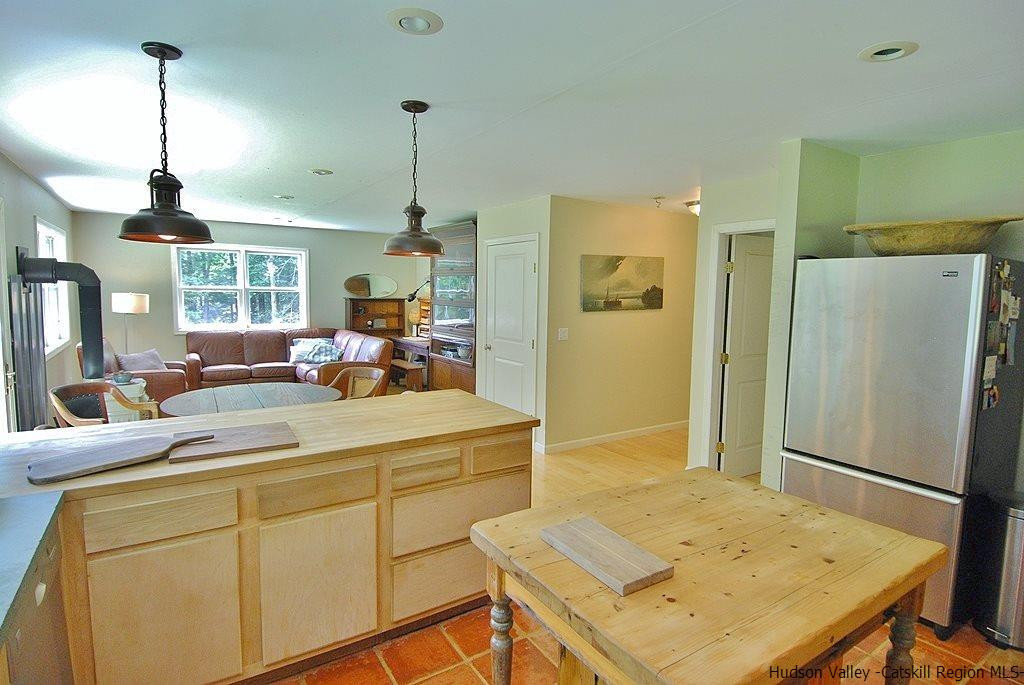 145 Beaverkill Road Kingston, NY 12401 - Photo 4 of 28 a kitchen with a refrigerator a stove and a dining table