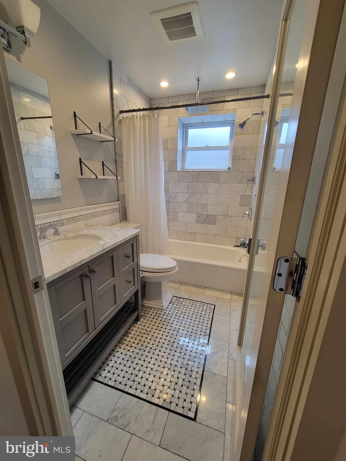3537 Sunnyside Avenue Philadelphia, PA 19129 - Photo 10 of 12 a bathroom with a sink a toilet a mirror and shower