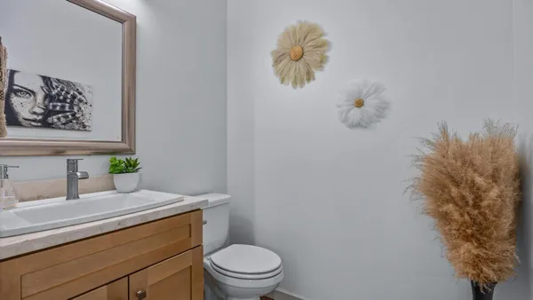 a bathroom with a granite countertop toilet sink and mirror