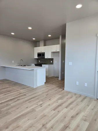 a kitchen with a sink cabinets and appliances