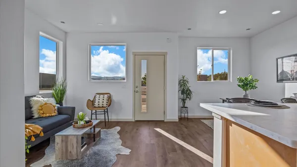 a dining room with furniture and wooden floor
