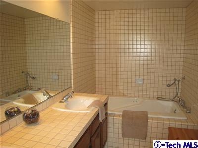Undisclosed Address Burbank, CA 91501 - Photo 15 of 21 a bathroom with a granite countertop sink and a bathtub